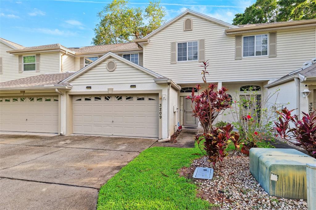 3209 Meta Court Largo, FL 33771 - Photo 2 of 24 a view of a house with a yard and potted plants