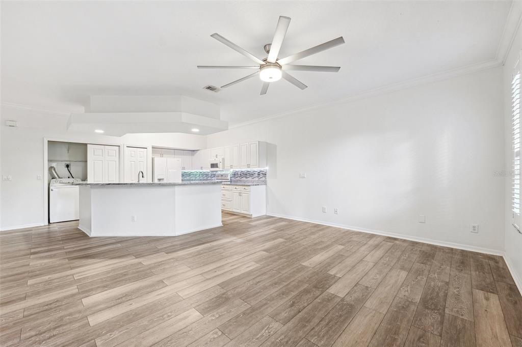 3209 Meta Court Largo, FL 33771 - Photo 7 of 24 a view of a kitchen with wooden floor and a ceiling fan