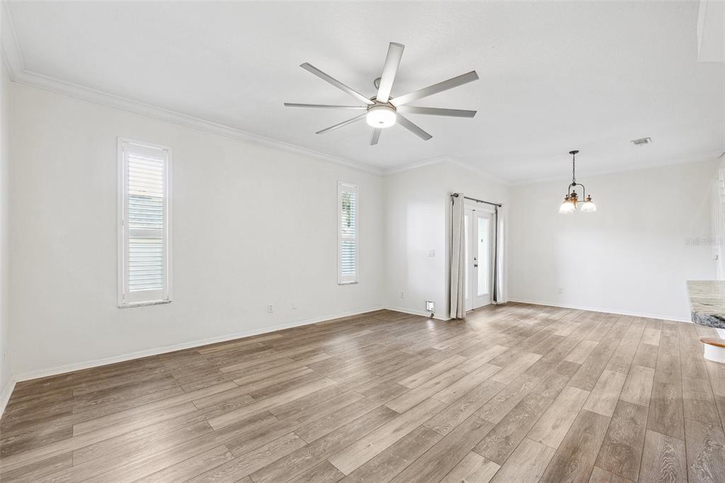 3209 Meta Court Largo, FL 33771 - Photo 9 of 24 a view of an empty room with wooden floor and a window