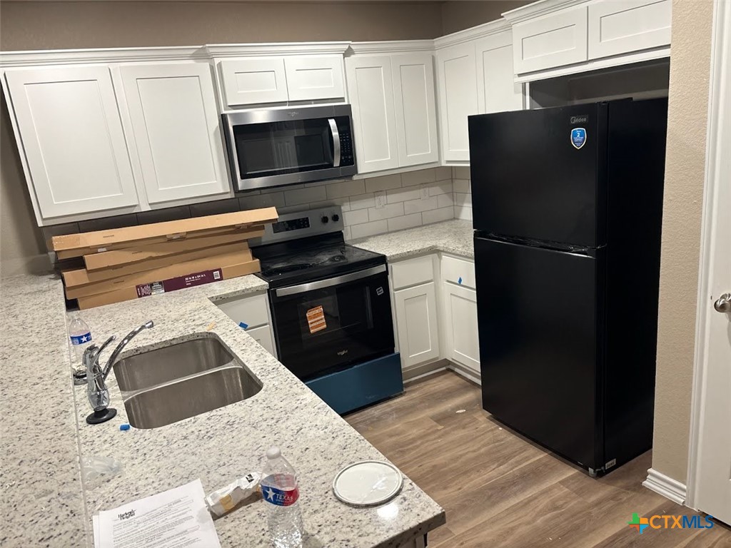 1610 Pima Trail, Unit A Harker Heights, TX 76548 - Photo 2 of 22 a kitchen with a refrigerator stove and microwave