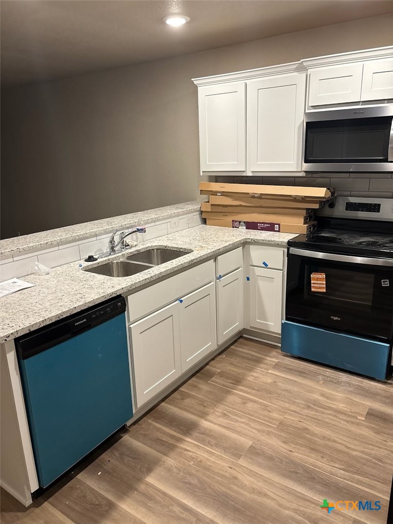 1610 Pima Trail, Unit A Harker Heights, TX 76548 - Photo 3 of 22 a kitchen with a sink stove and microwave