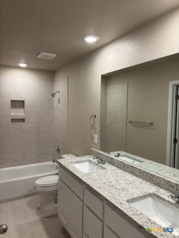 1610 Pima Trail, Unit A Harker Heights, TX 76548 - Photo 7 of 22 a bathroom with a granite countertop sink a toilet and shower