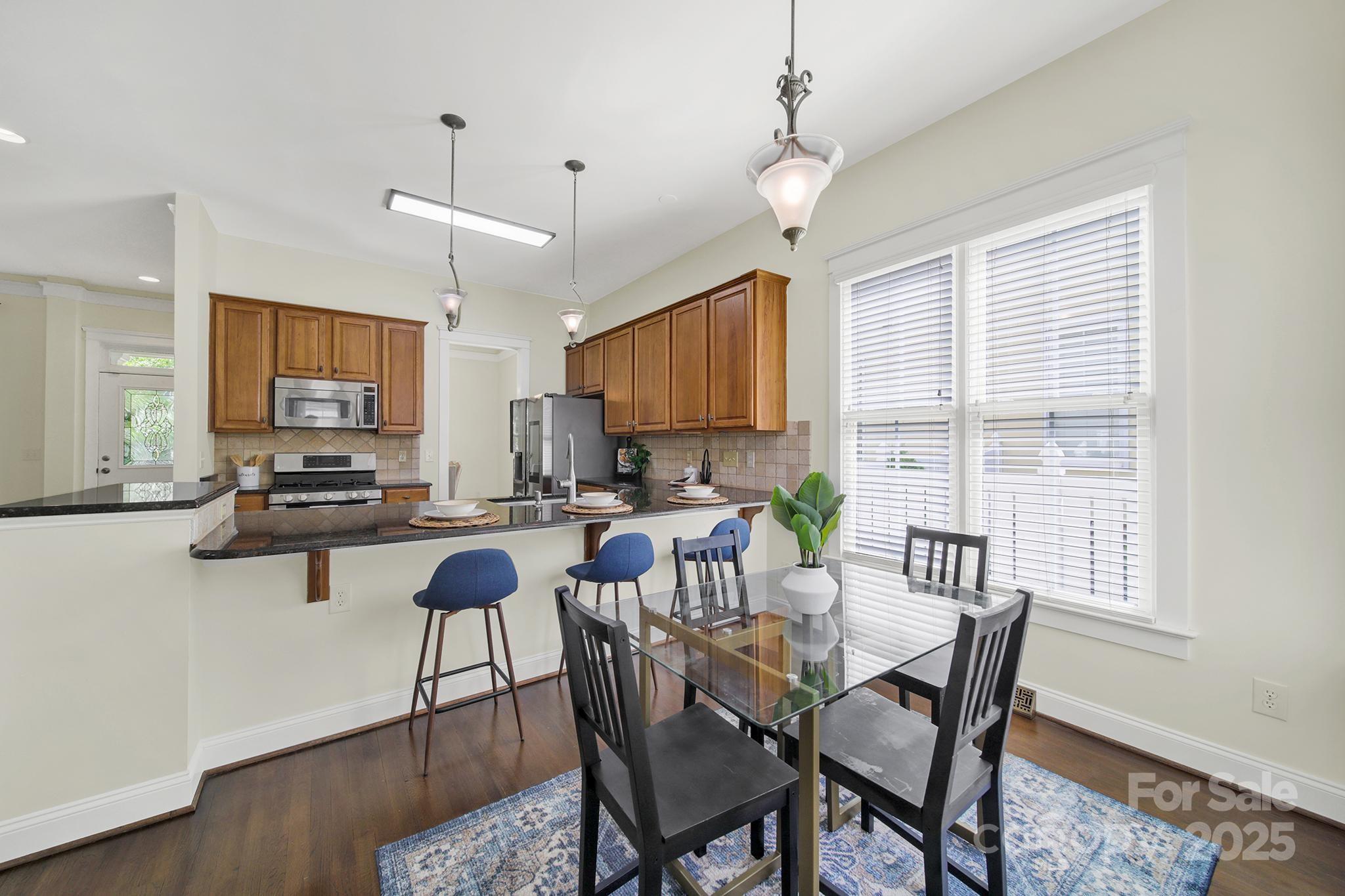1855 2nd Baxter Crossing Fort Mill, SC 29708 - Photo 13 of 48 a view of a dining room with furniture window and wooden floor
