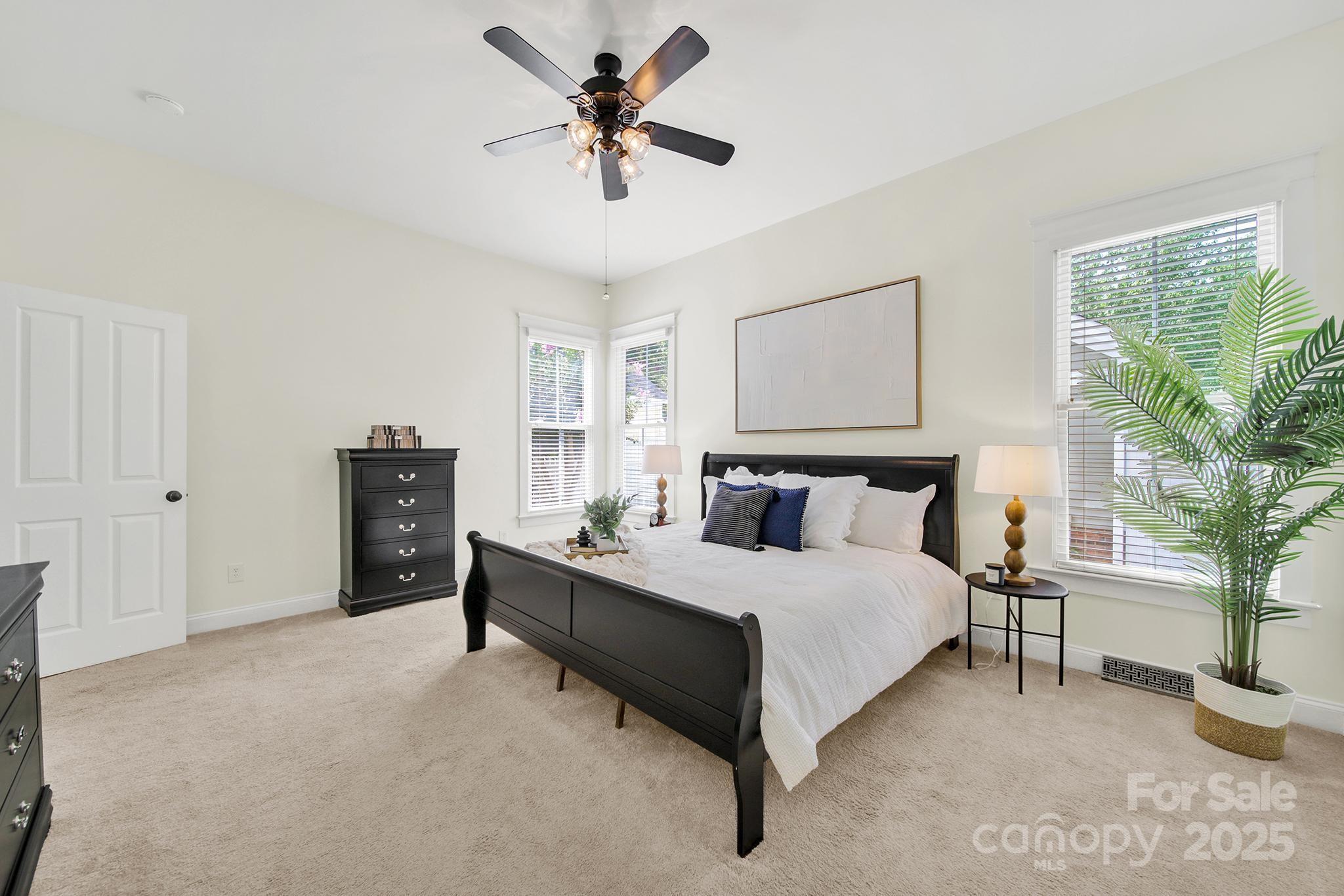 1855 2nd Baxter Crossing Fort Mill, SC 29708 - Photo 15 of 48 a spacious bedroom with a bed a couch and a potted plant