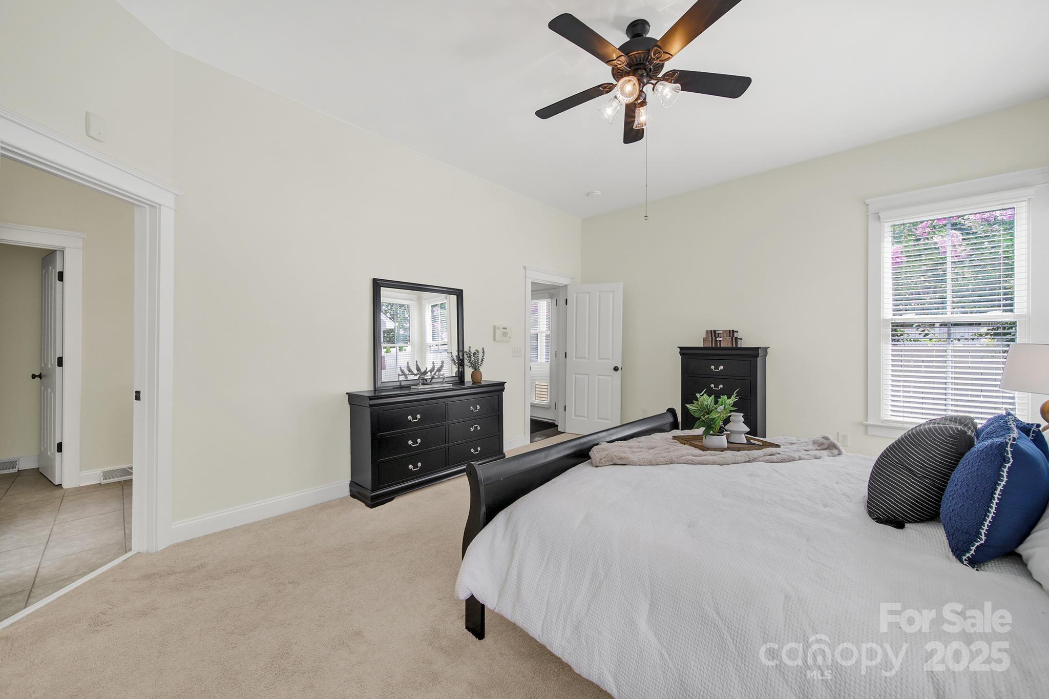 1855 2nd Baxter Crossing Fort Mill, SC 29708 - Photo 18 of 48 a bedroom with a bed a ceiling fan and a window