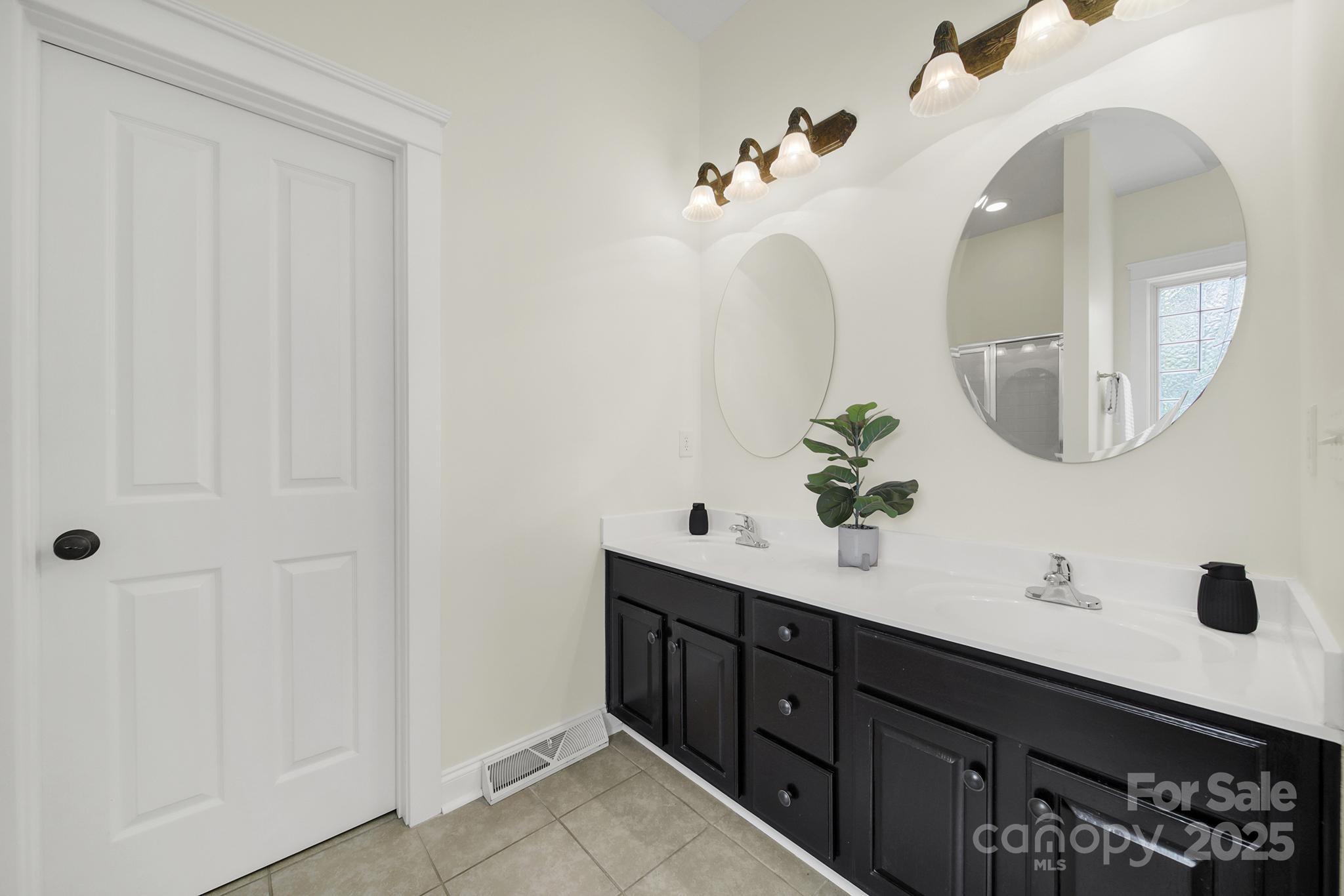 1855 2nd Baxter Crossing Fort Mill, SC 29708 - Photo 19 of 48 a bathroom with a double vanity sink and a mirror