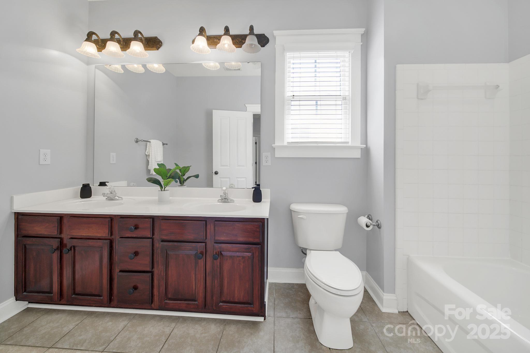 1855 2nd Baxter Crossing Fort Mill, SC 29708 - Photo 26 of 48 a bathroom with a toilet a sink and mirror