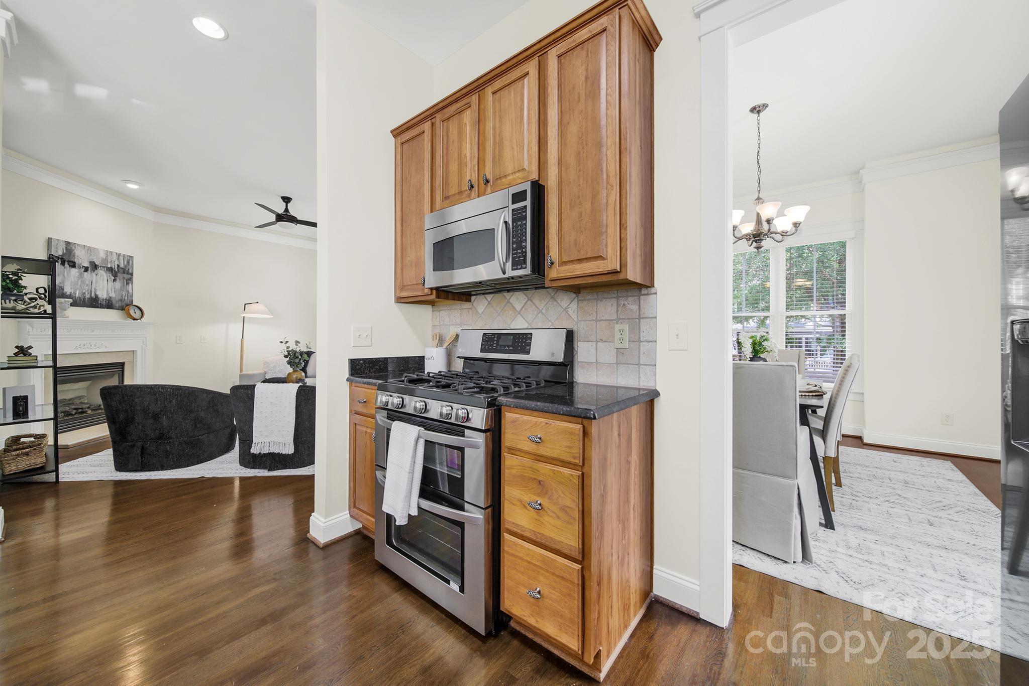 1855 2nd Baxter Crossing Fort Mill, SC 29708 - Photo 9 of 48 a kitchen with stainless steel appliances granite countertop a stove a sink and a microwave