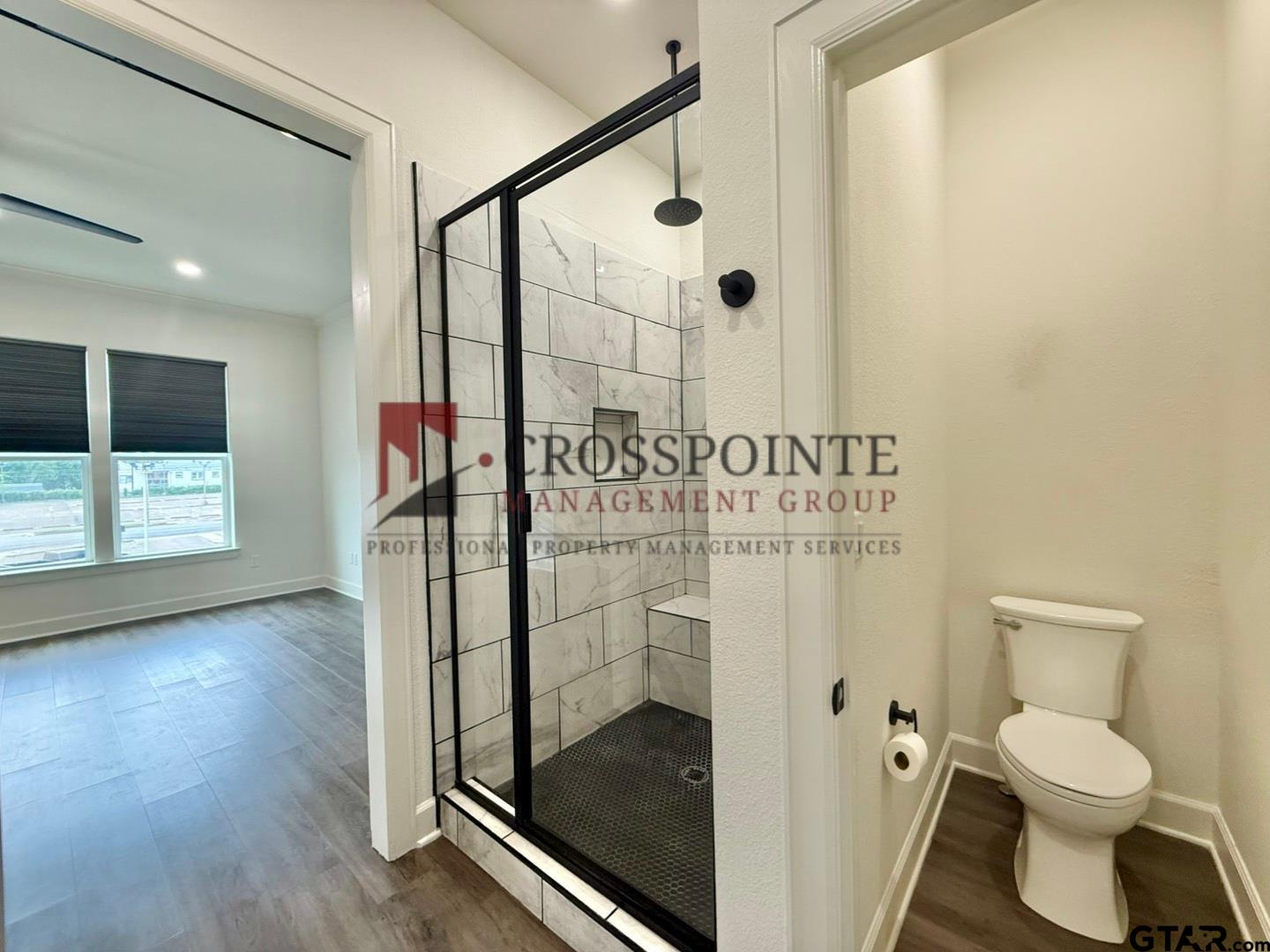 548 West Erwin Street Tyler, TX 75702 - Photo 19 of 27 a bathroom with a toilet and a shower