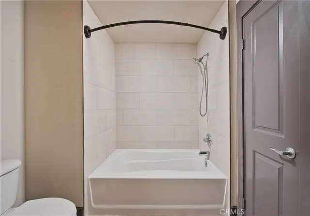 a bathroom with a shower and a toilet