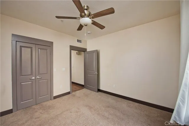 an empty room with a ceiling fan and a ceiling fan