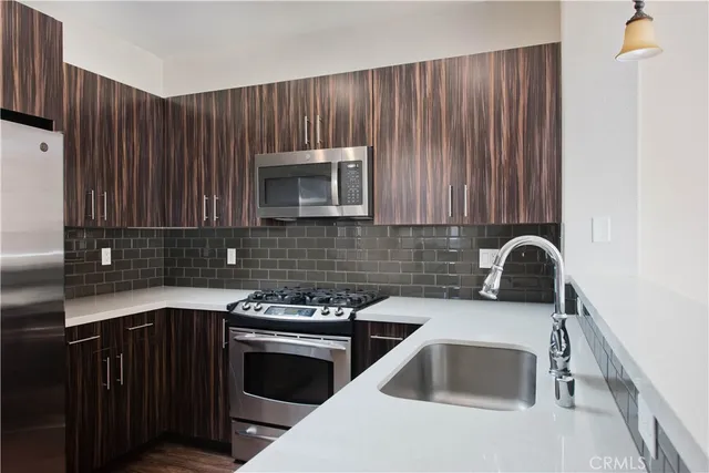 a kitchen with a sink and a stove top oven