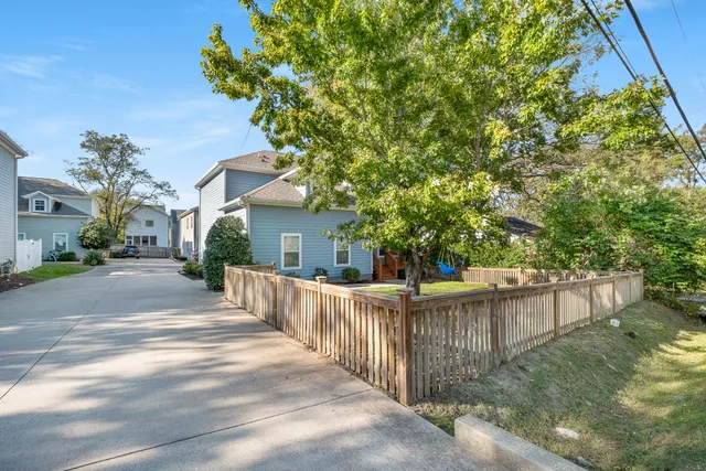 a view of a house with wooden fence