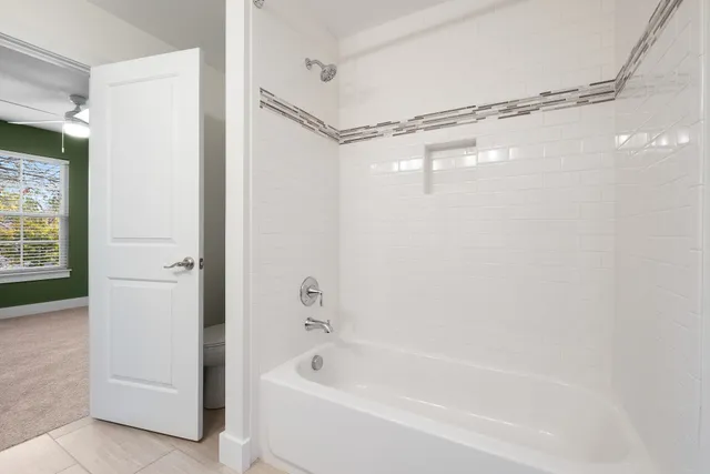 an empty room with closet and fan