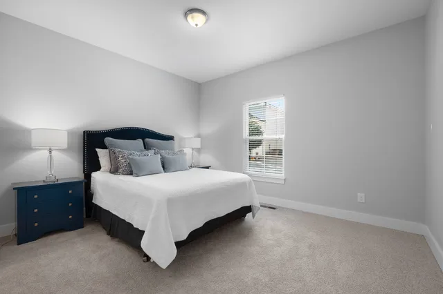 a living room with furniture and a mirror