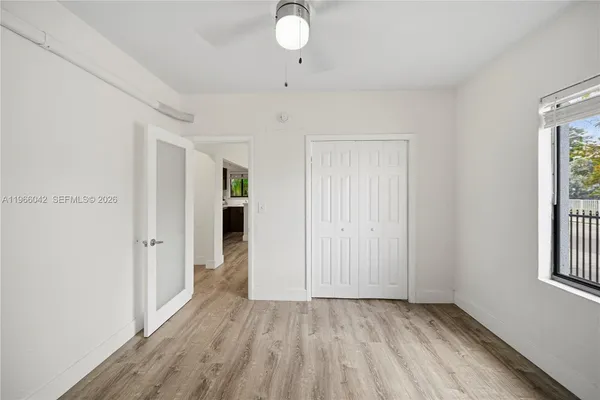 wooden floor in an empty room with a window