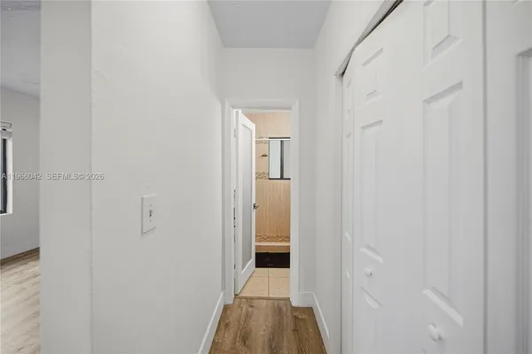 a view of a hallway with wooden floor