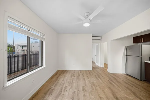 a view of a livingroom with wooden floor and an empty space