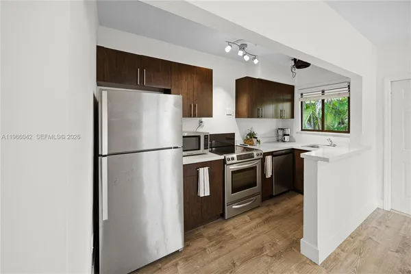 a kitchen with stainless steel appliances a refrigerator stove and microwave