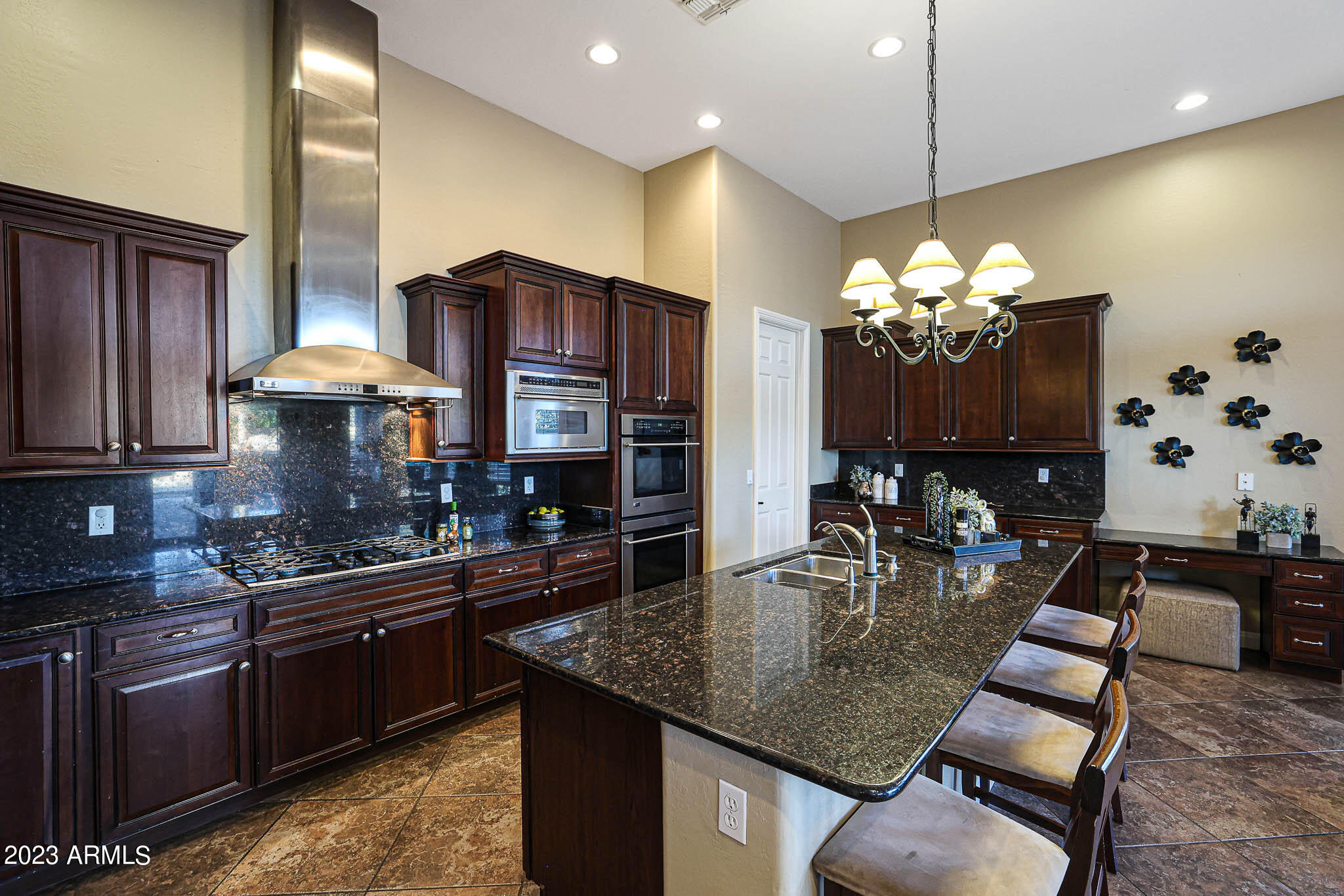 4935 West Yearling Road Phoenix, AZ 85083 - Photo 14 of 57 a kitchen with stainless steel appliances granite countertop a stove a sink a counter space and cabinets