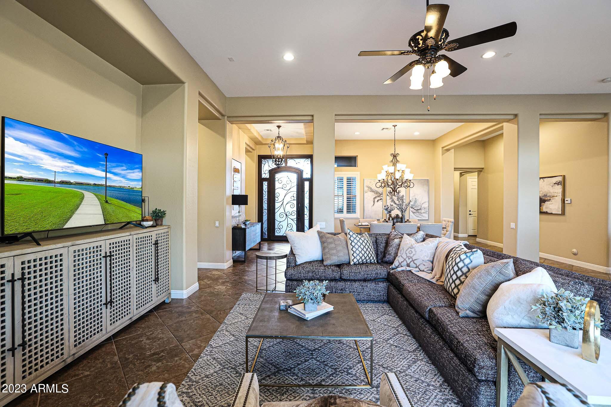 4935 West Yearling Road Phoenix, AZ 85083 - Photo 18 of 57 a living room with furniture and a flat screen tv
