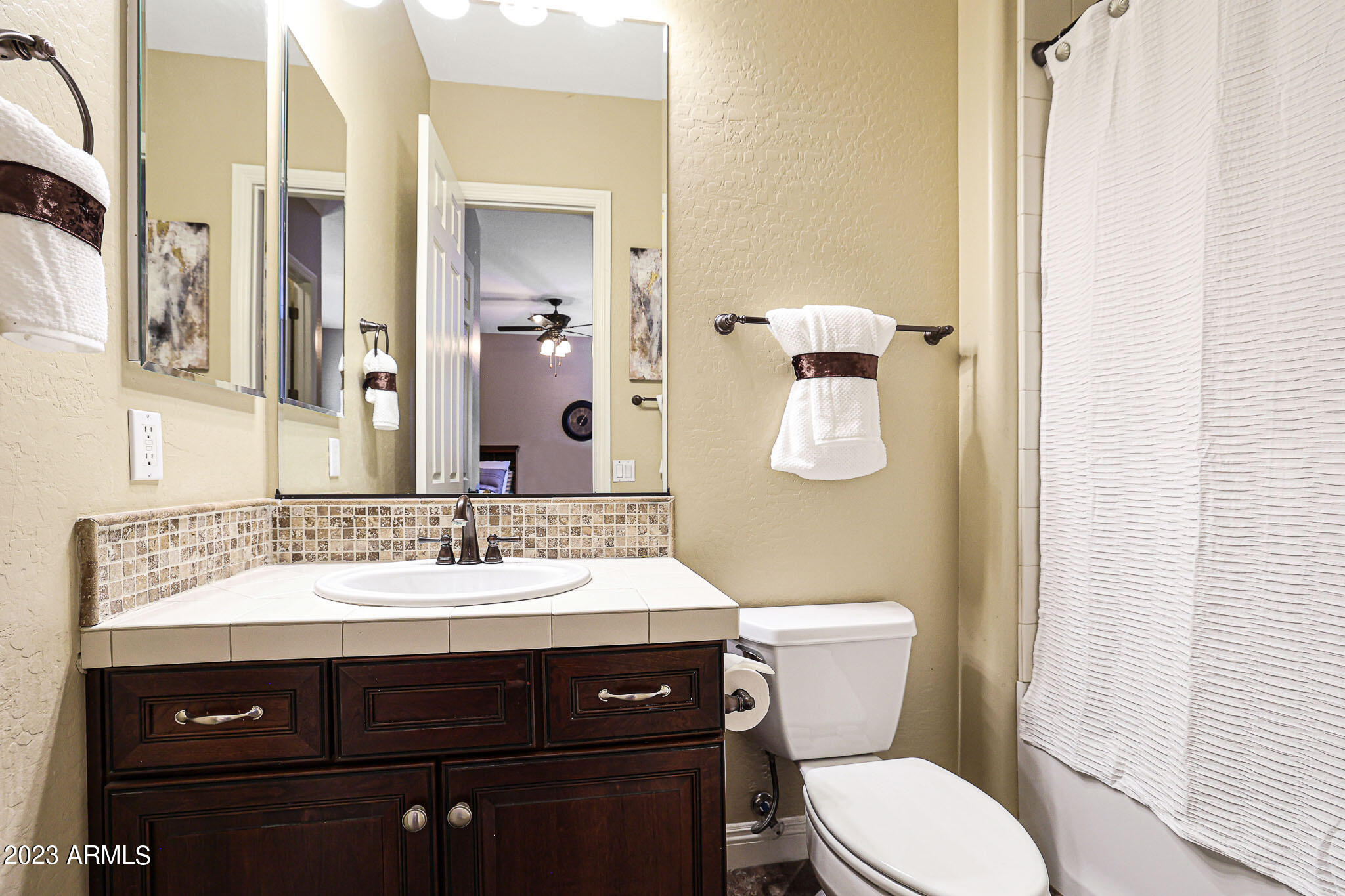4935 West Yearling Road Phoenix, AZ 85083 - Photo 27 of 57 a bathroom with a sink vanity mirror and toilet