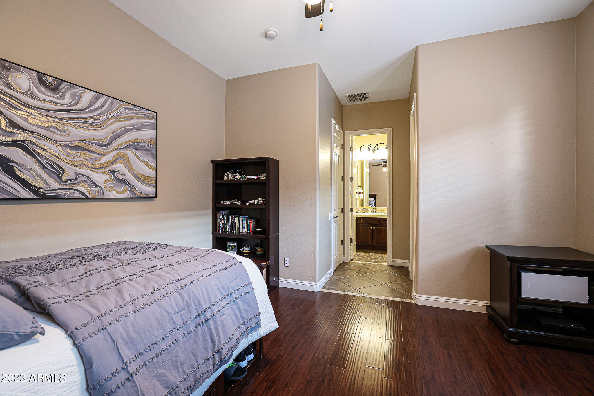 4935 West Yearling Road Phoenix, AZ 85083 - Photo 28 of 57 a bedroom with a bed and wooden floor
