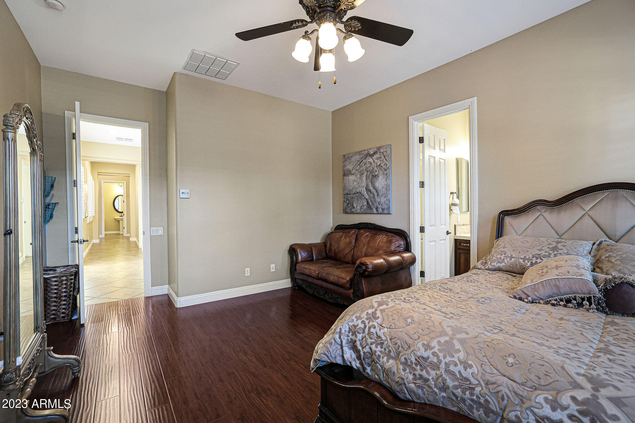 4935 West Yearling Road Phoenix, AZ 85083 - Photo 29 of 57 a bedroom with a bed and a chandelier