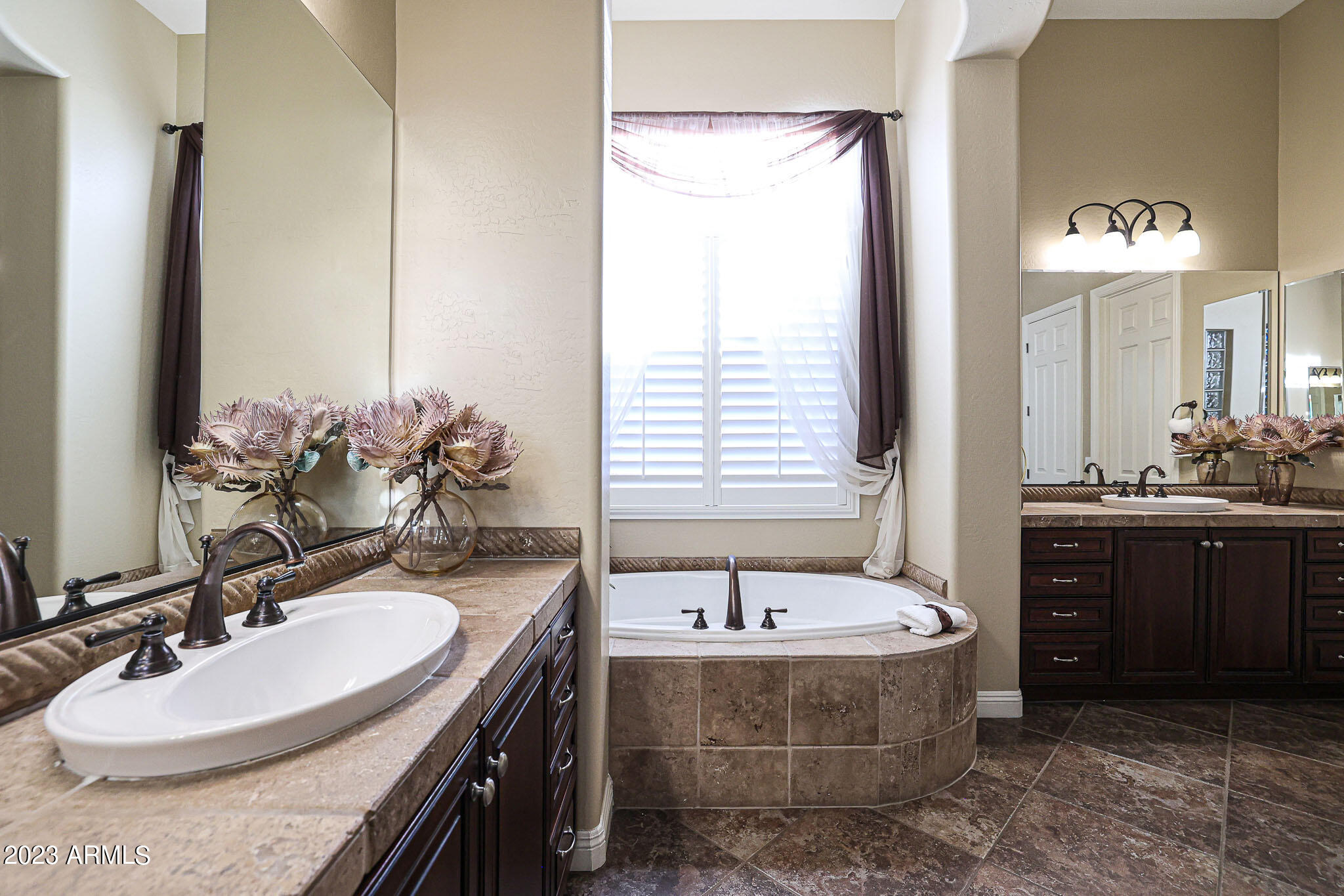 4935 West Yearling Road Phoenix, AZ 85083 - Photo 36 of 57 a bathroom with a tub sink and mirror