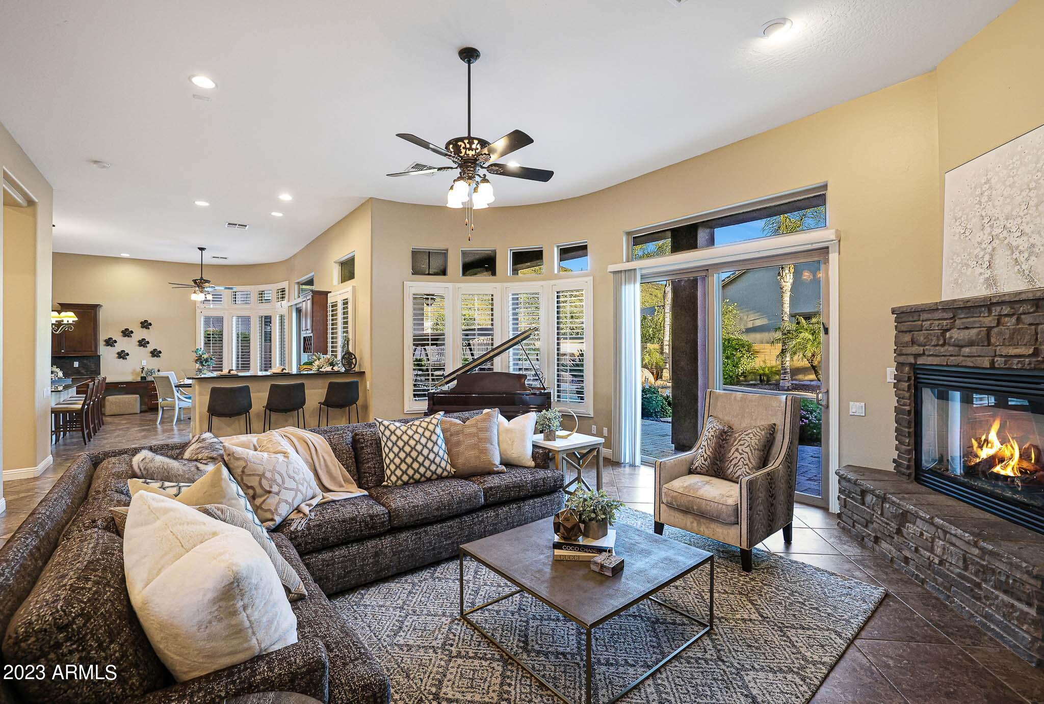 4935 West Yearling Road Phoenix, AZ 85083 - Photo 4 of 57 a living room with furniture fireplace and a flat screen tv