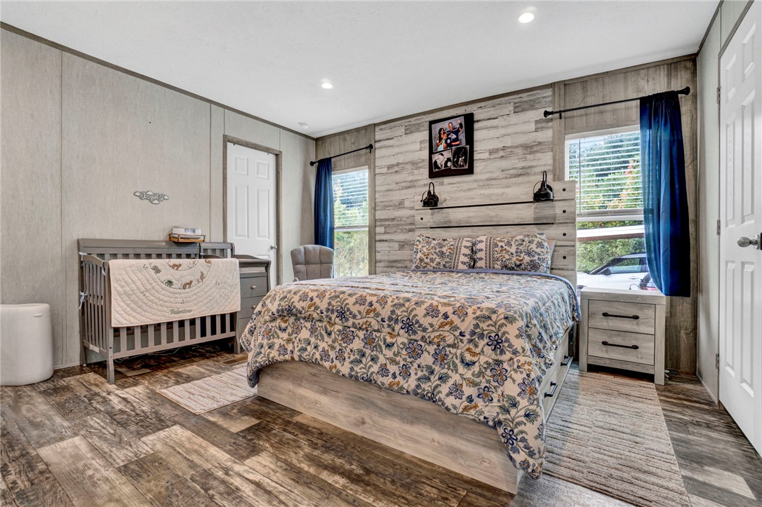 2655 State Rd S-4-108 Anderson, SC 29624 - Photo 12 of 37 Rustic wood-look paneling and matching floors highlight this versatile bedroom space.