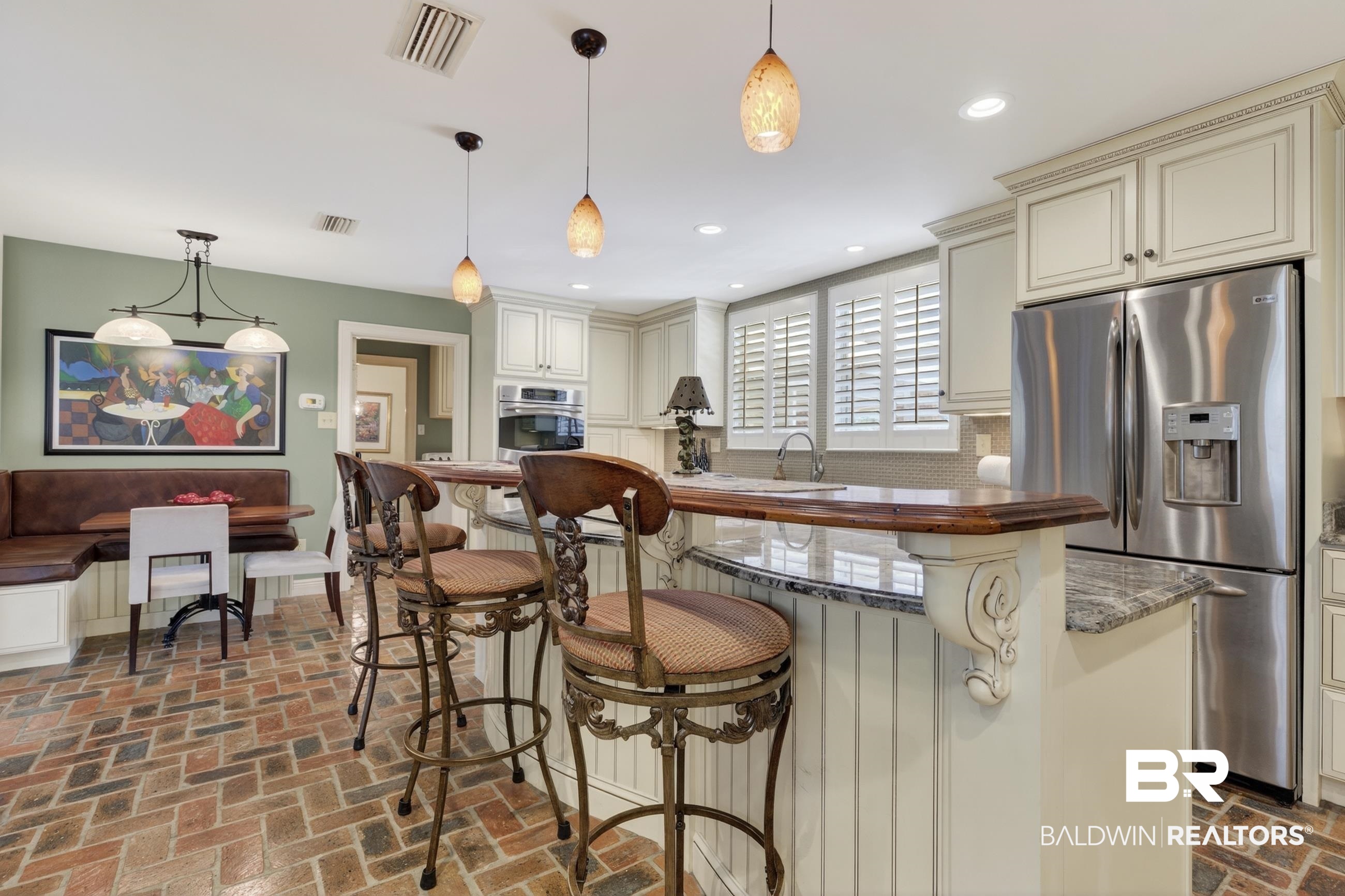 3175 Dawes Lake Road Mobile, AL 36619 - Photo 23 of 92 Kitchen with stainless steel appliances, cream cabinets, a breakfast bar, and brick floors