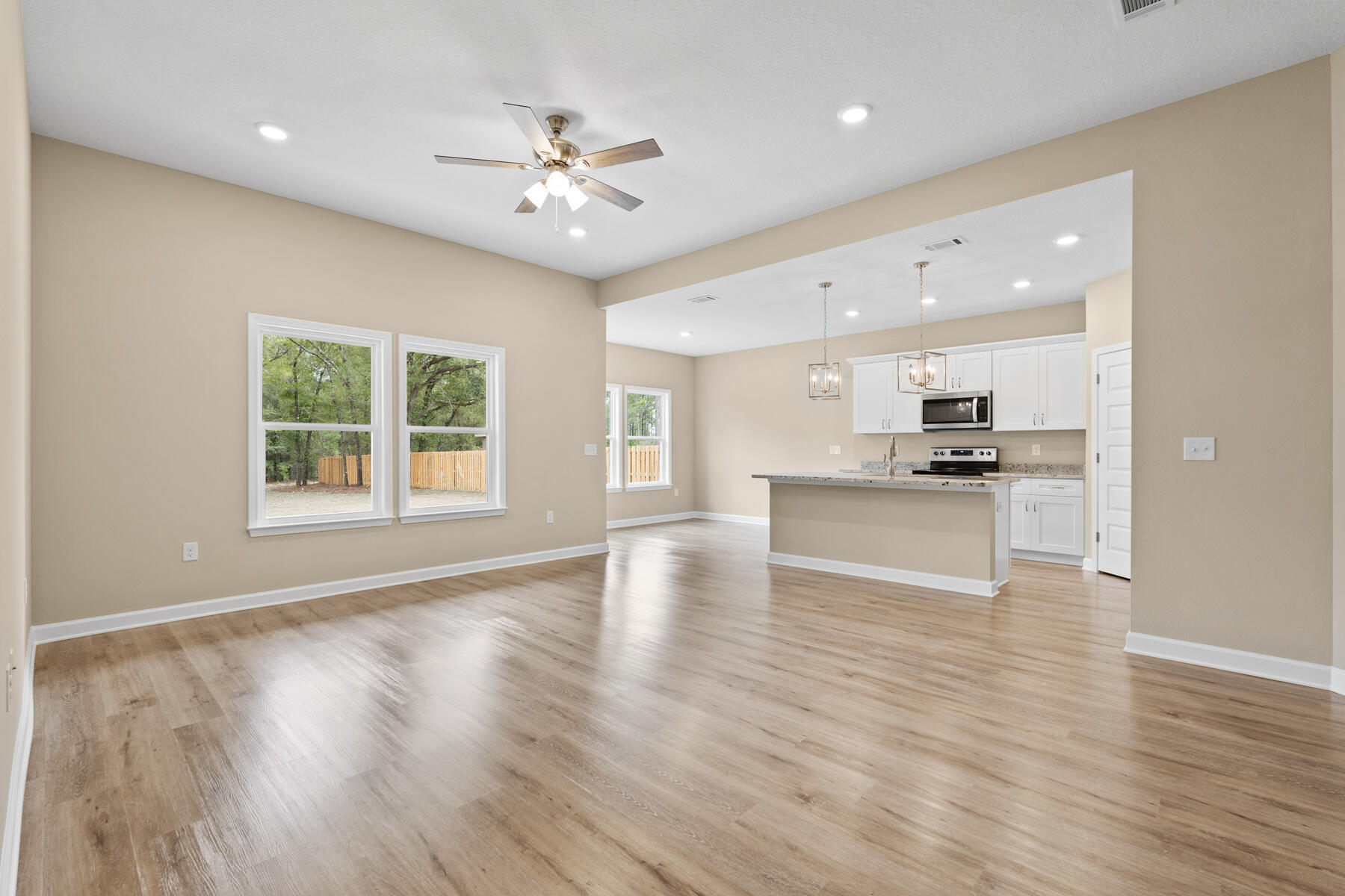 2544 Kingston Road Crestview, FL 32536 - Photo 6 of 20 a view of an empty room with kitchen and window