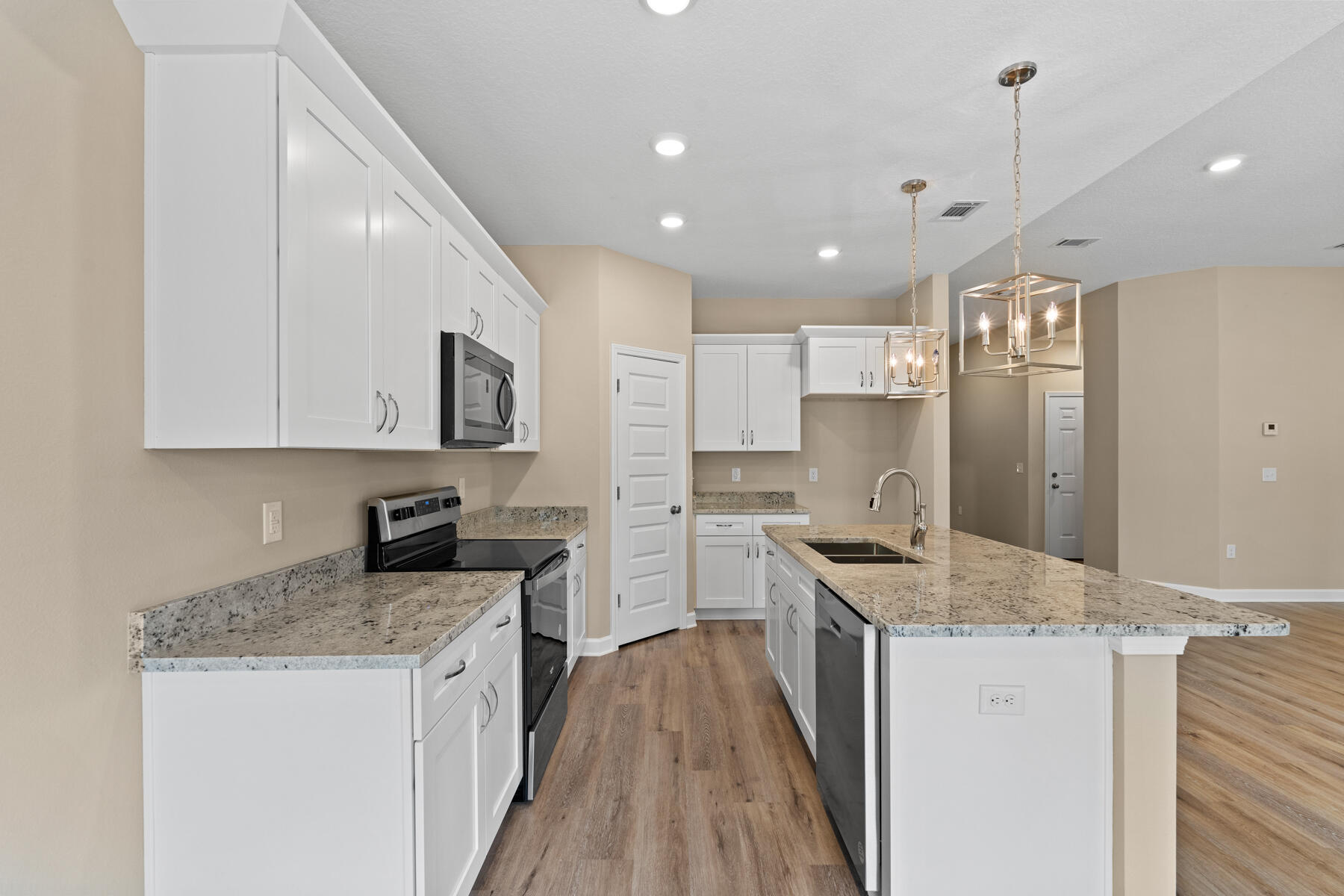 2544 Kingston Road Crestview, FL 32536 - Photo 8 of 20 a kitchen with stainless steel appliances granite countertop a sink stove and refrigerator