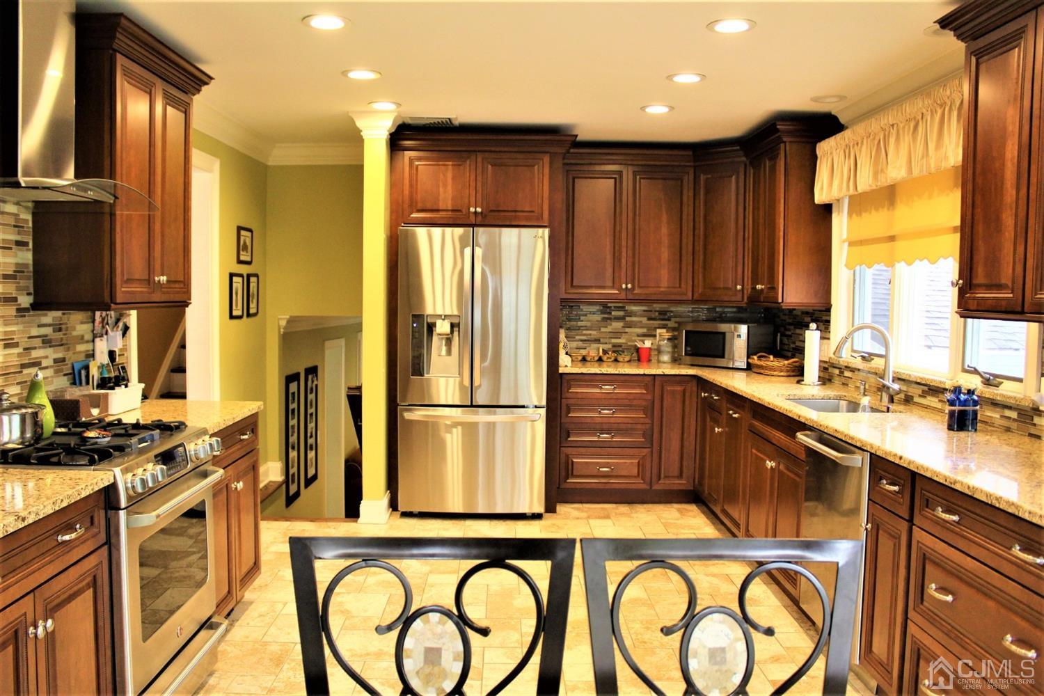 10 Fishel Road Edison, NJ 08820 - Photo 2 of 11 a kitchen with stainless steel appliances granite countertop a refrigerator a sink a stove and island