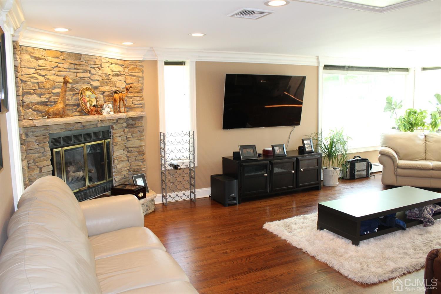 10 Fishel Road Edison, NJ 08820 - Photo 8 of 11 a living room with furniture a flat screen tv and a fireplace