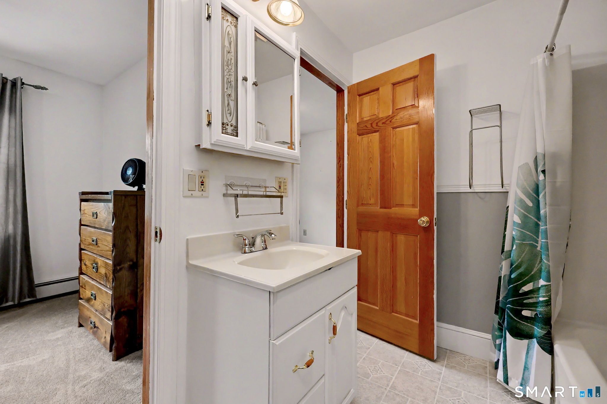 7 Merrill Road Trumbull, CT 06611 - Photo 31 of 40 a bathroom with a sink a mirror and a shower