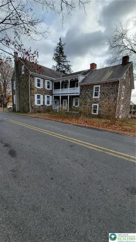 a front view of a brick house with a large window