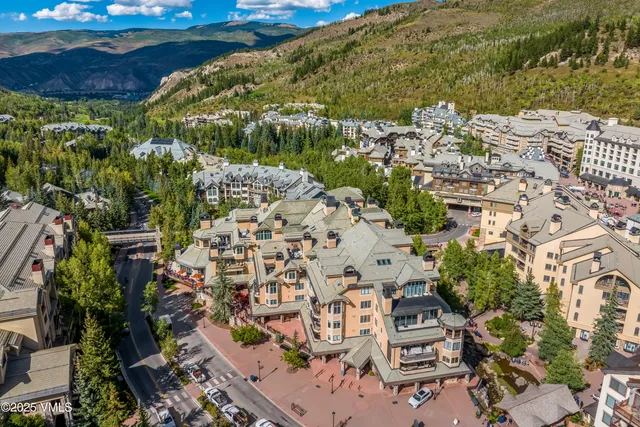 a view of water fountain with tree in the background