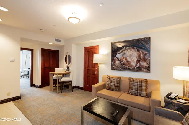 a living room with furniture and a piano