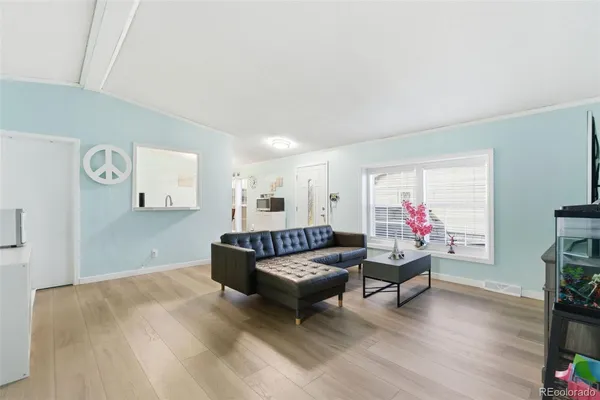 a living room with furniture and wooden floor