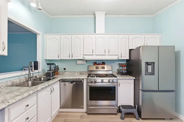 a kitchen with a white cabinets and white appliances