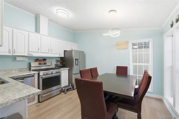 a view of kitchen with sink dining table and chairs