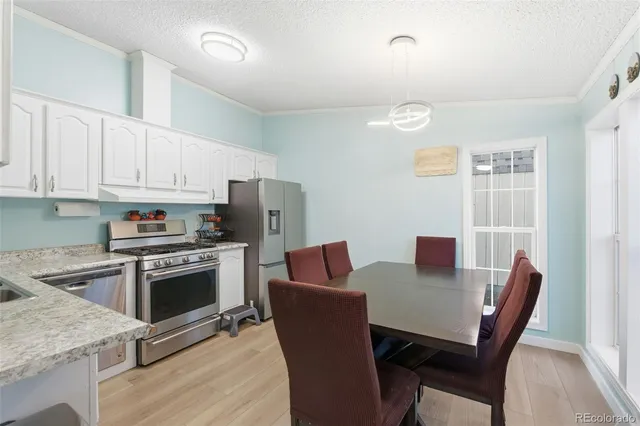 a view of kitchen with sink dining table and chairs