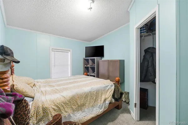 a bedroom that has a bed and a tv in it