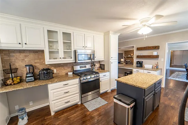 a kitchen with granite countertop a stove oven and sink