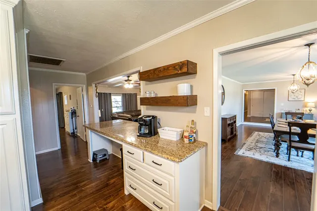 a kitchen with sink and refrigerator