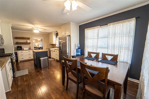 a view of a dining room with furniture and wooden floor
