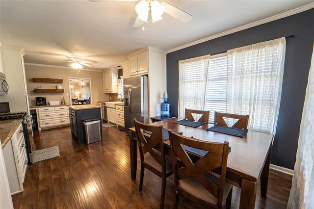 a view of a dining room with furniture and wooden floor