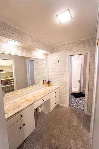 a spacious bathroom with a sink a large mirror and a bathtub